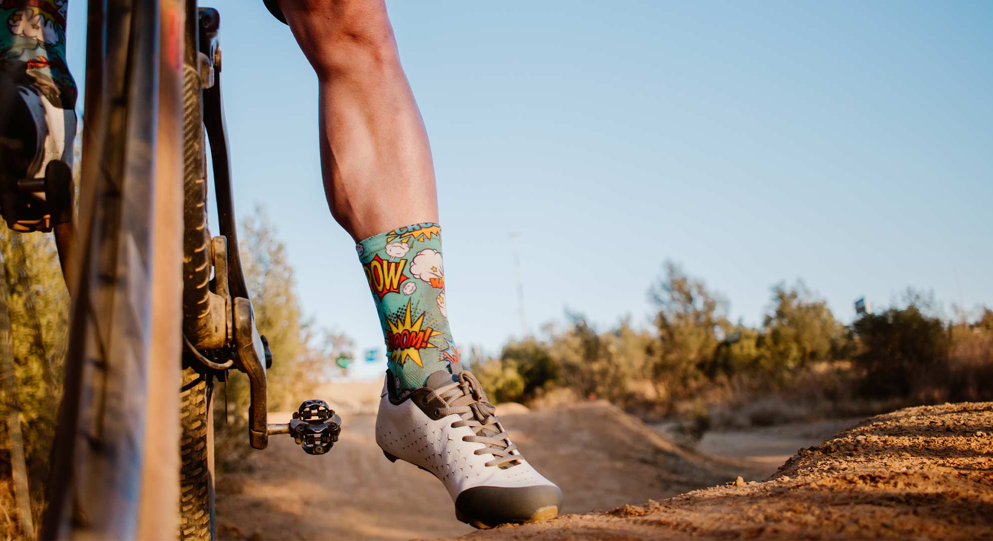 Man on a bike wearing a Sox brand pair of socks