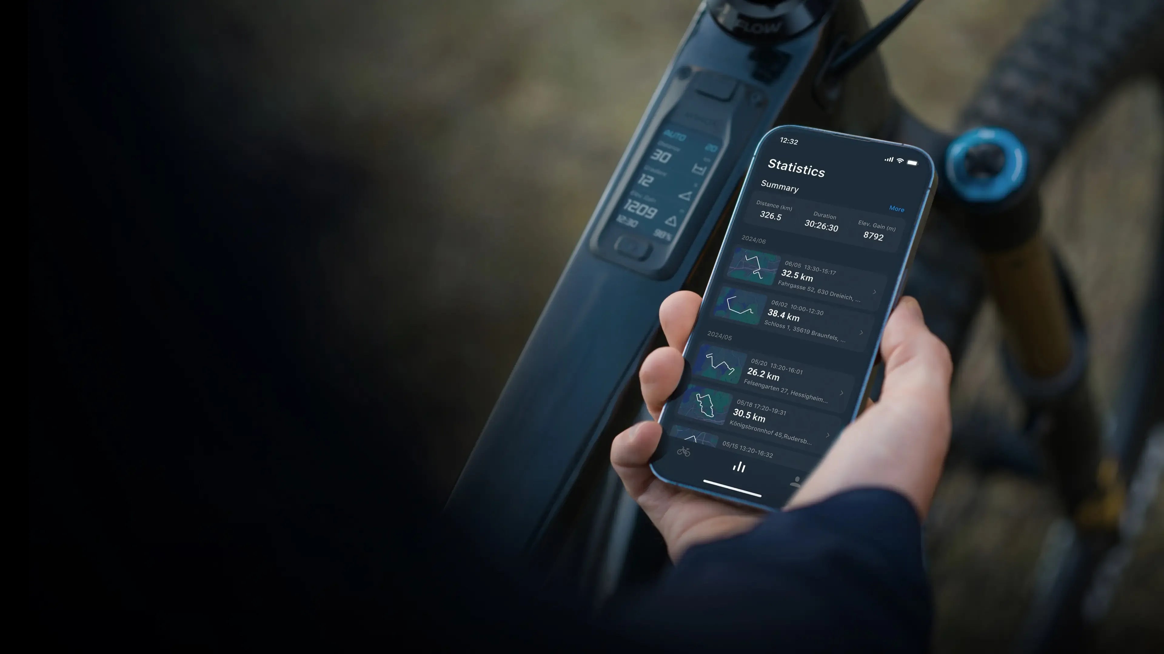 Person holding a smartphone with a cycling app displayed, next to a bicycle.