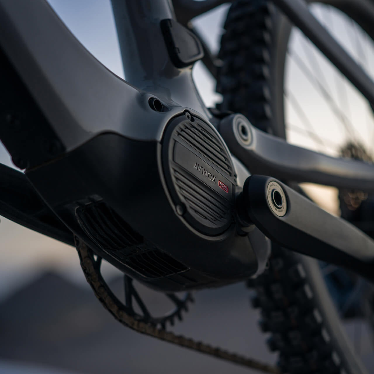 Close-up of a mid drive Avinox motor on an electric mountain bike with a blurred background