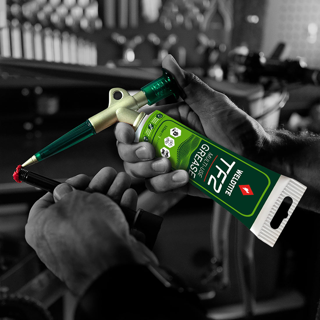 A picture of the Weldtite TF2 Multi-Use Grease being used on a bike