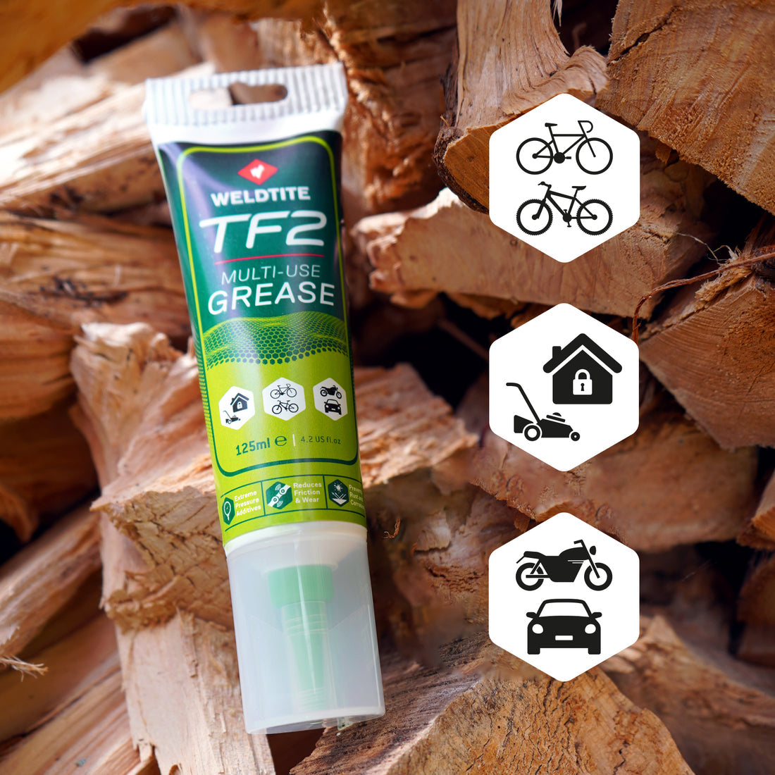 A picture of the Weldtite TF2 Multi-Use Grease with a backdrop of chopped wood