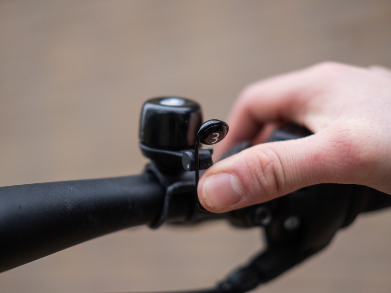 A picture of someone ringing a bicycle bell