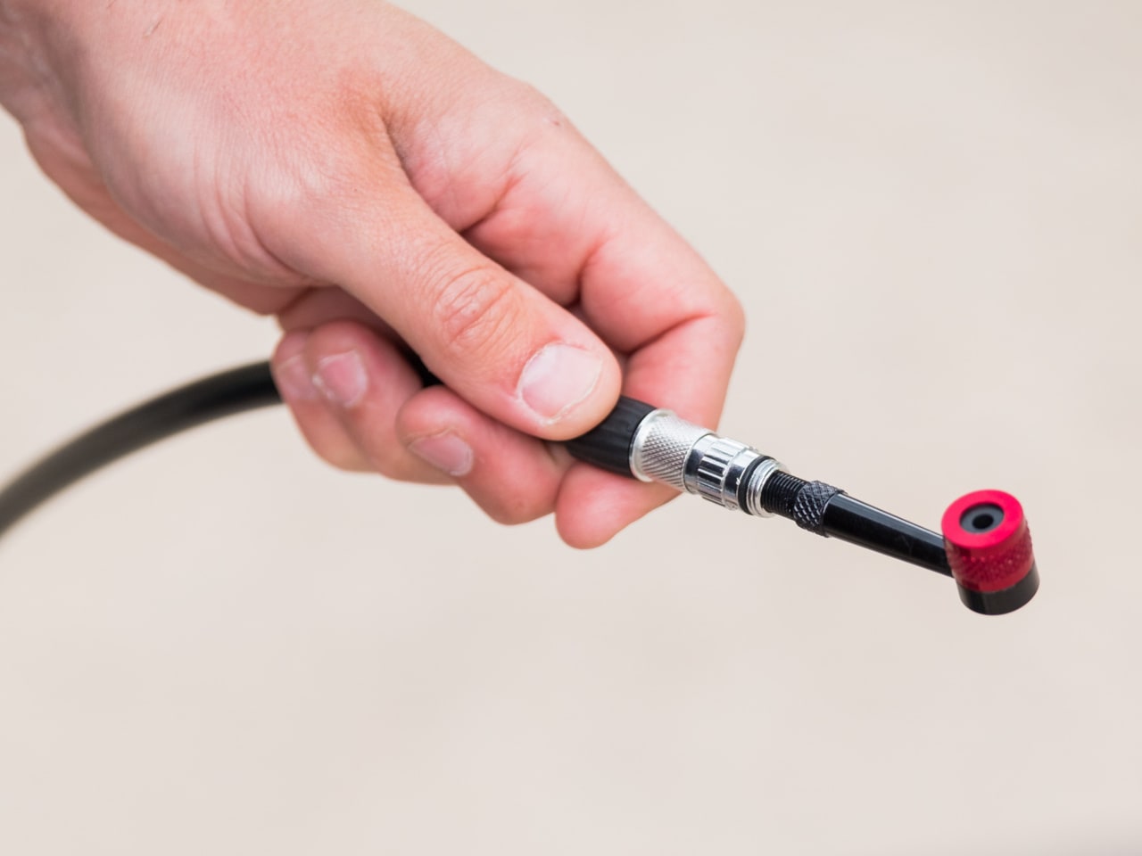 A picture of the BBB Airpipe Pumphead Adapter attached to a pump hose