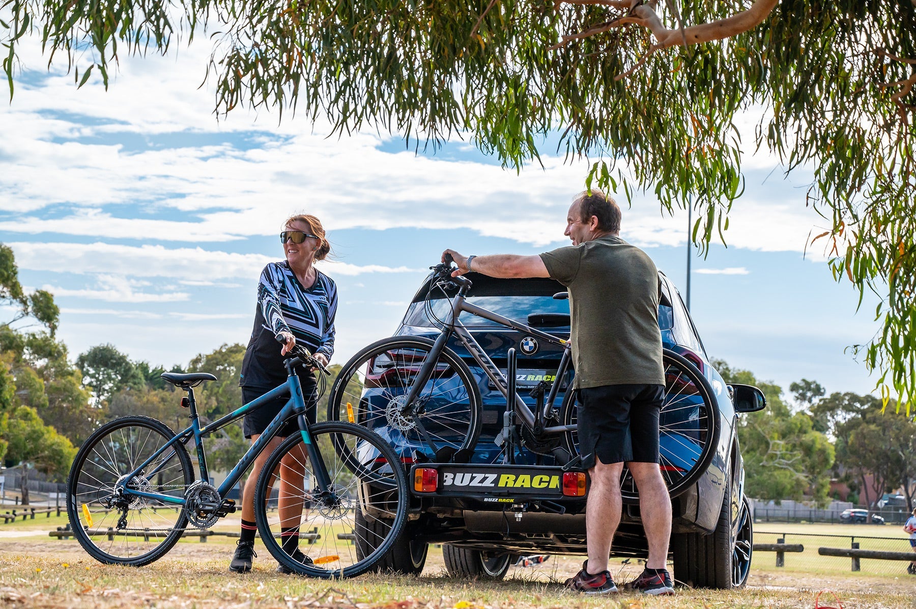 A picture of the Buzzrack Buzzybee H2 (Hitch) 2 Bike Rack mounted to a car with bikes