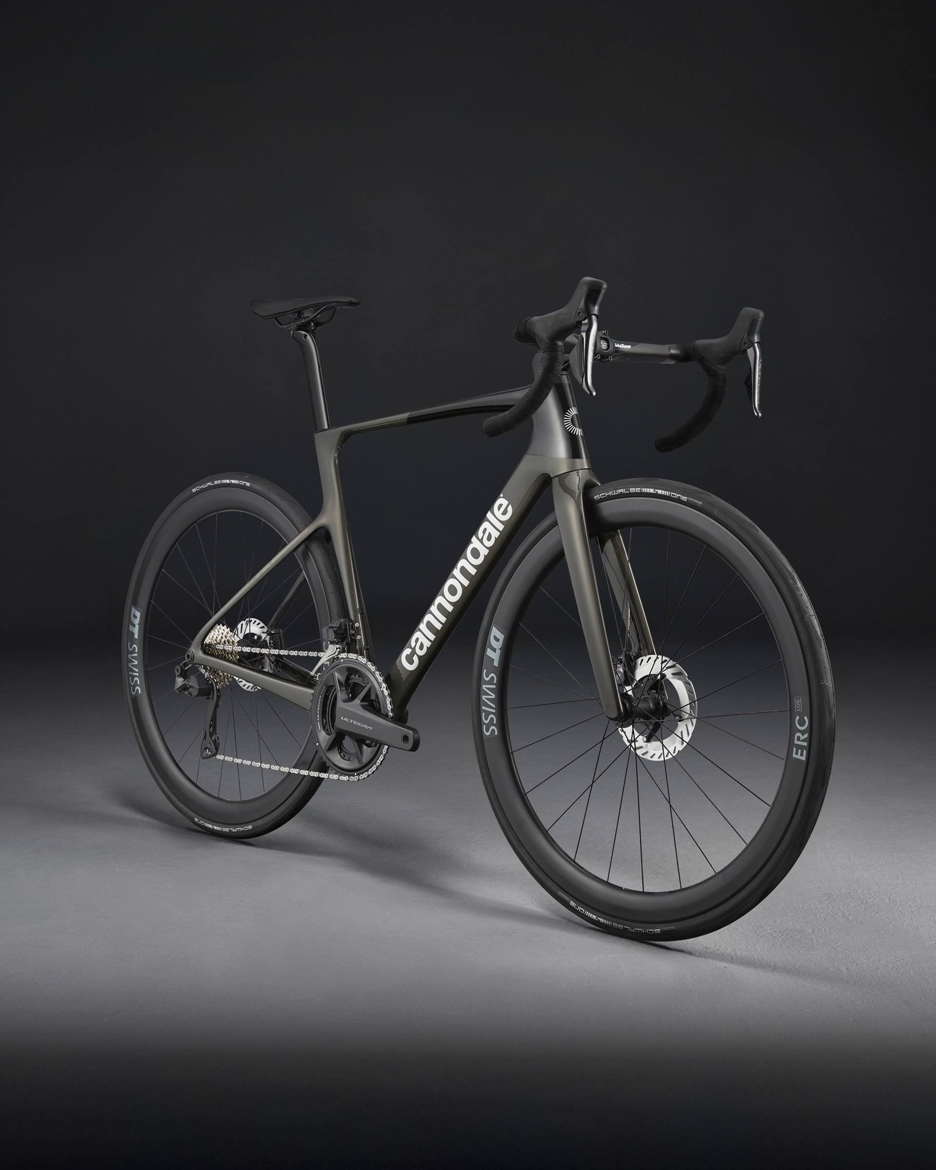 A charcoal Cannondale bicycle on a dark background