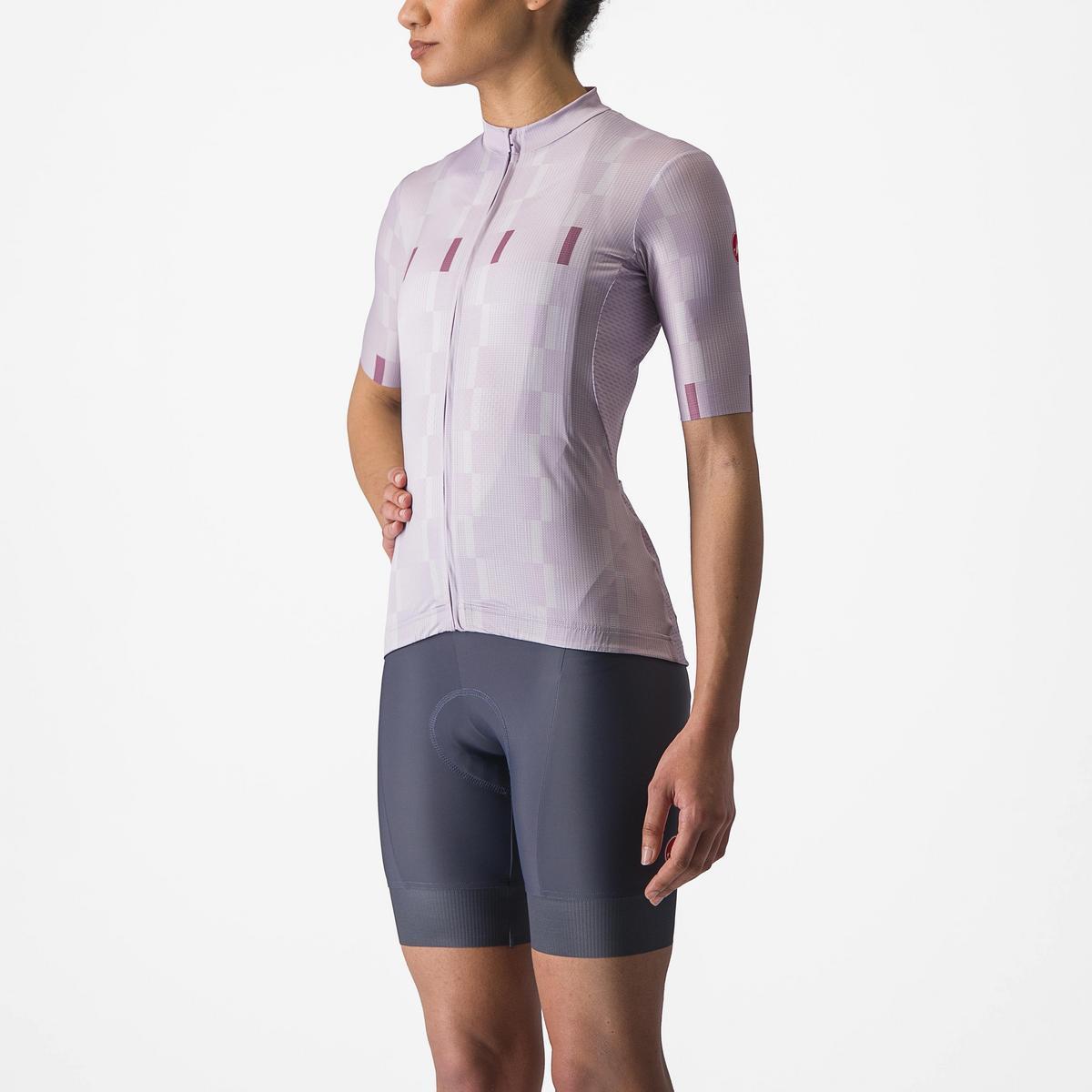 Person wearing a light purple cycling jersey and dark gray shorts on a white background