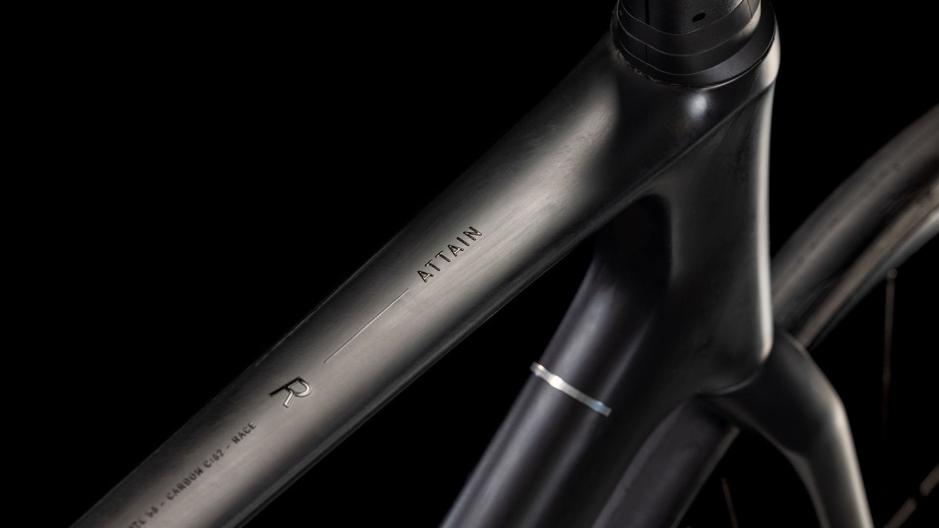 Close-up of a black bicycle frame with a black background