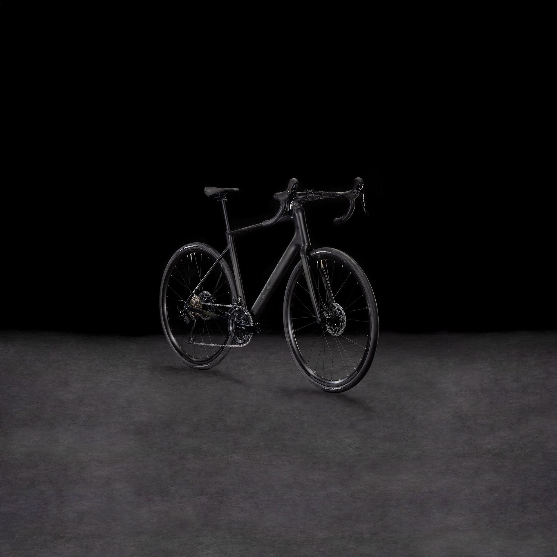 Black bicycle on a dark background