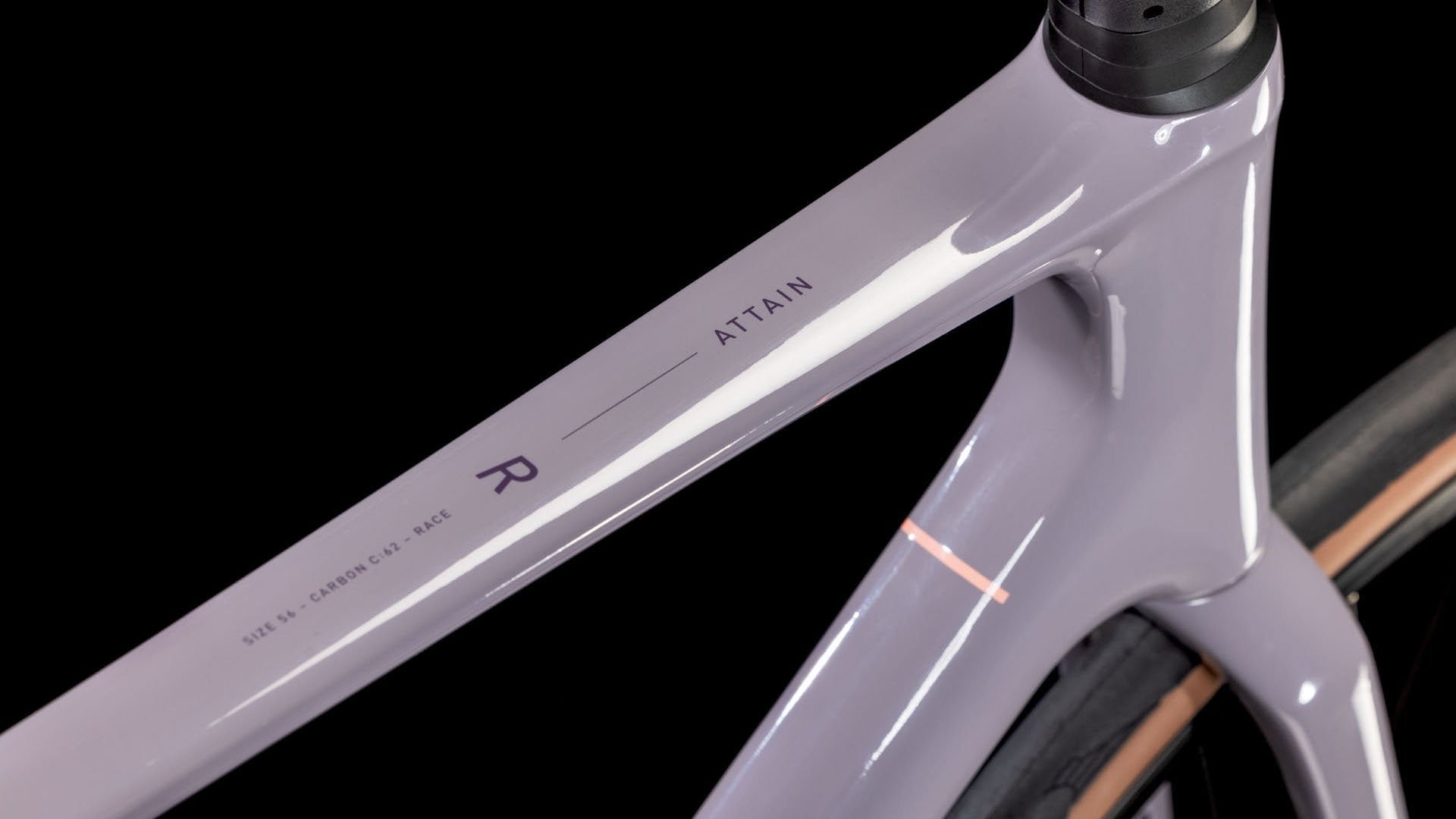 Close-up of a light purple bicycle frame on a black background