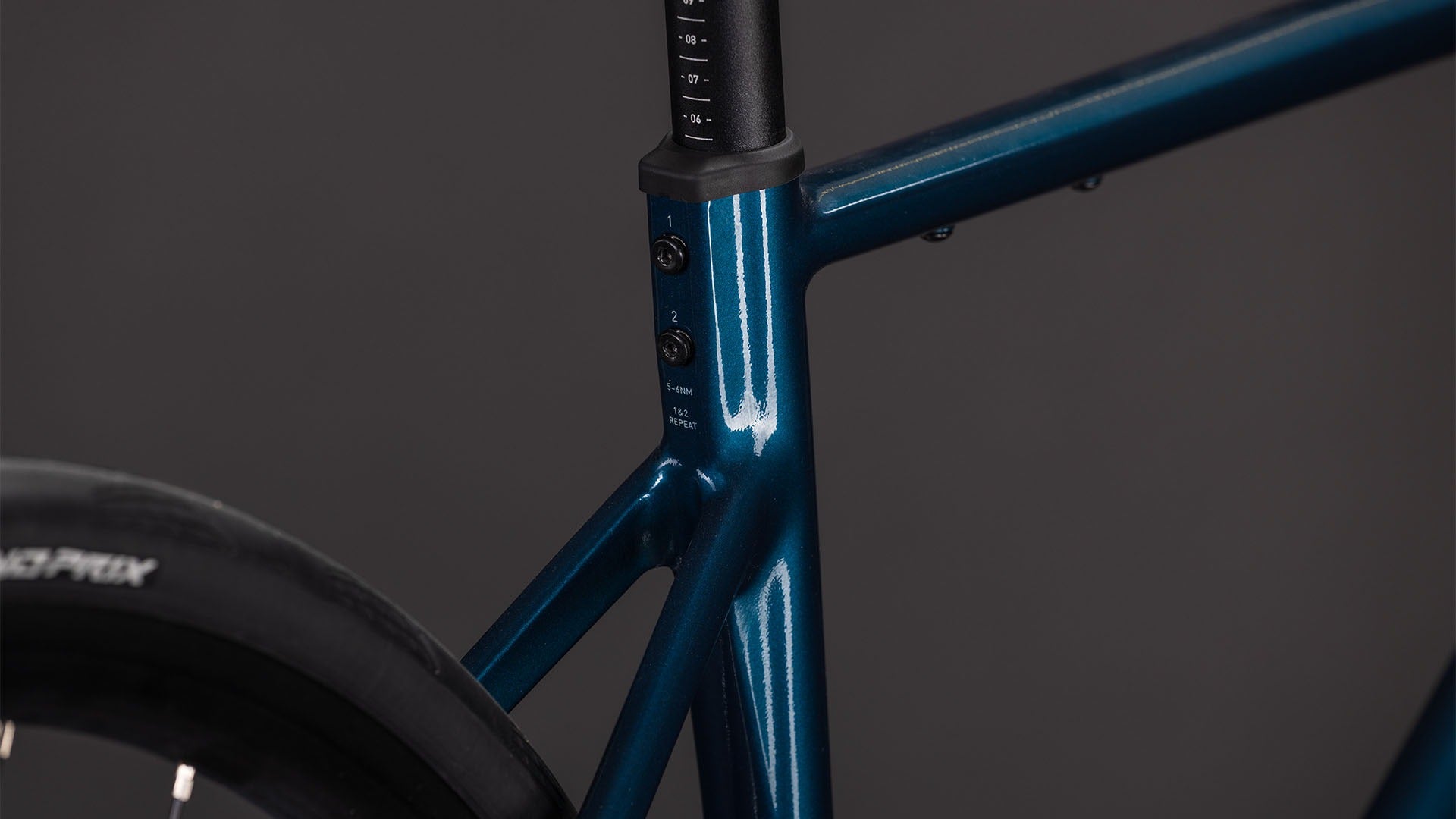 Close-up of a blue road bike frame on a dark background
