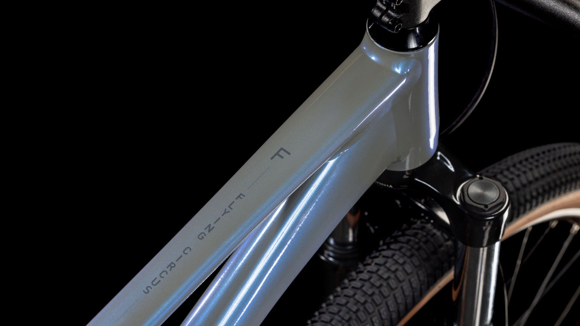 Close-up of a bicycle frame with visible branding on a black background