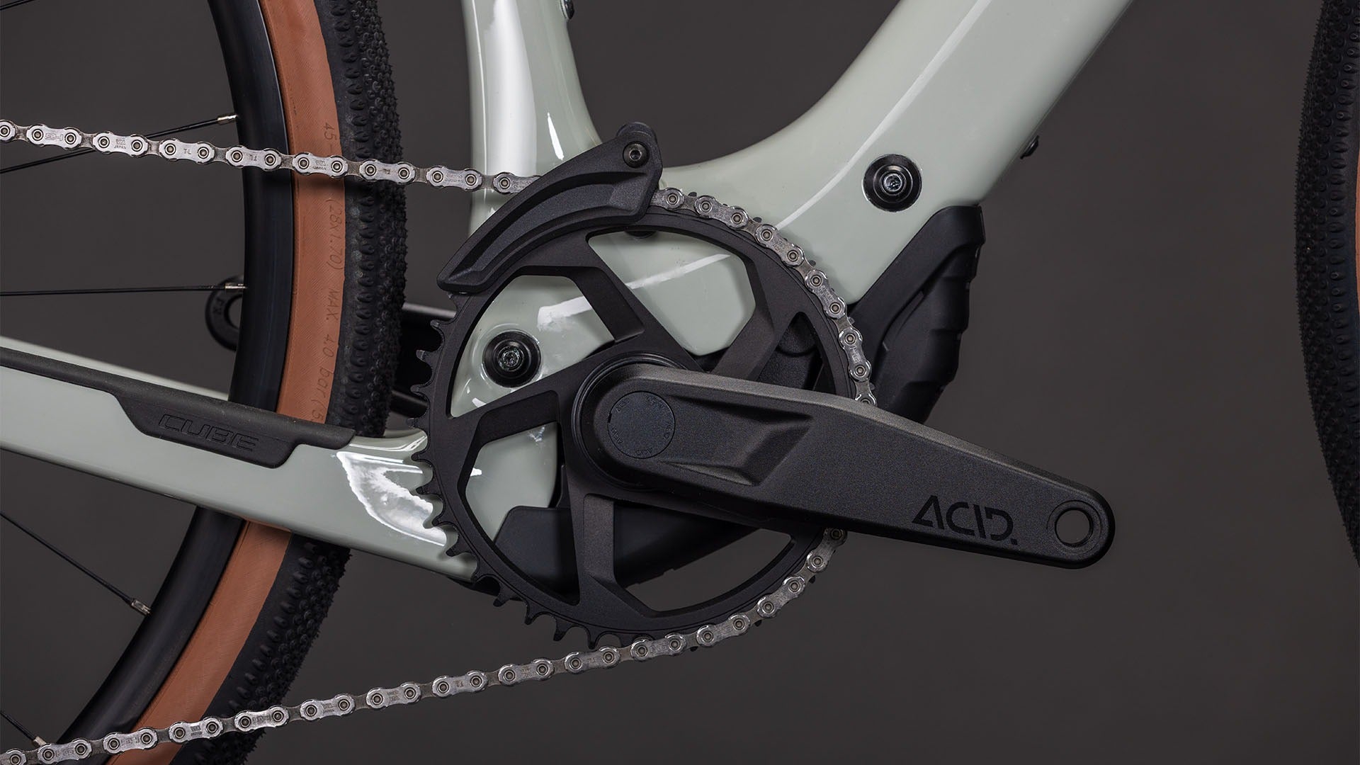 Close-up of a bicycle chain and gear system on a dark background