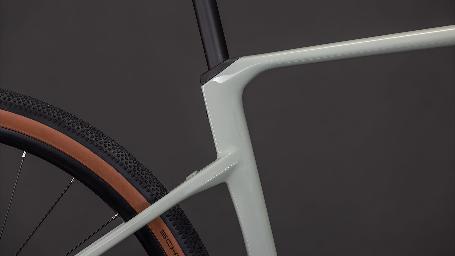 Close-up of a bicycle frame and wheel on a dark background