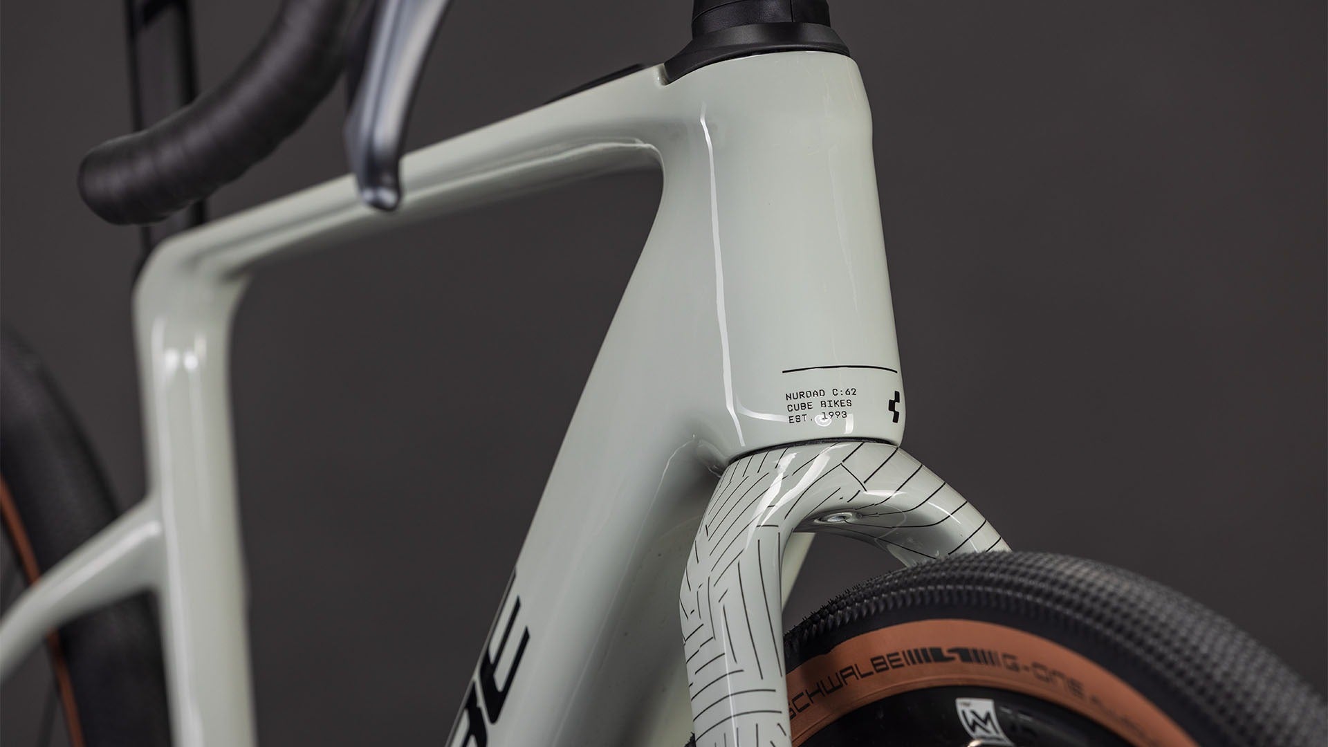 Close-up of the front of a gravel bike frame with a dark background