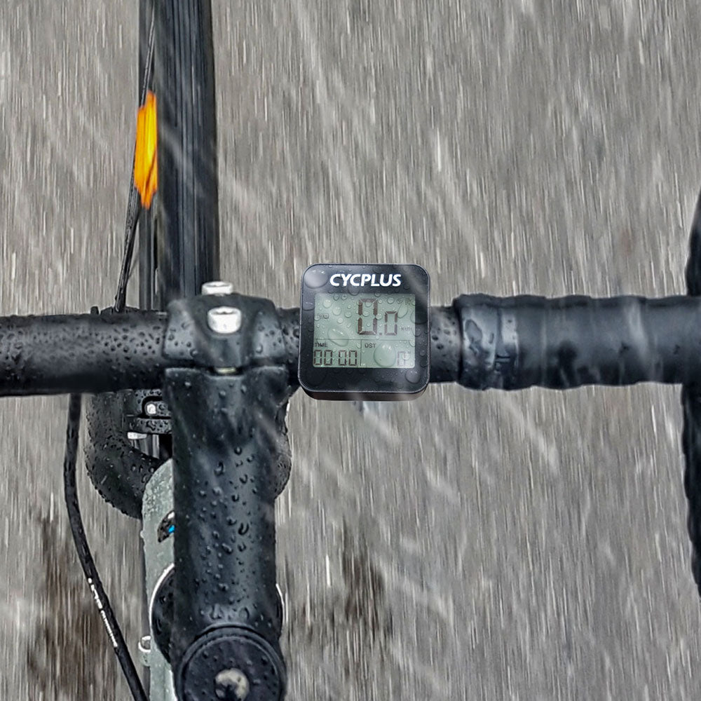 A picture of the Cycplus G1 GPS Cycling Computer mounted on a road bike on a rainy day