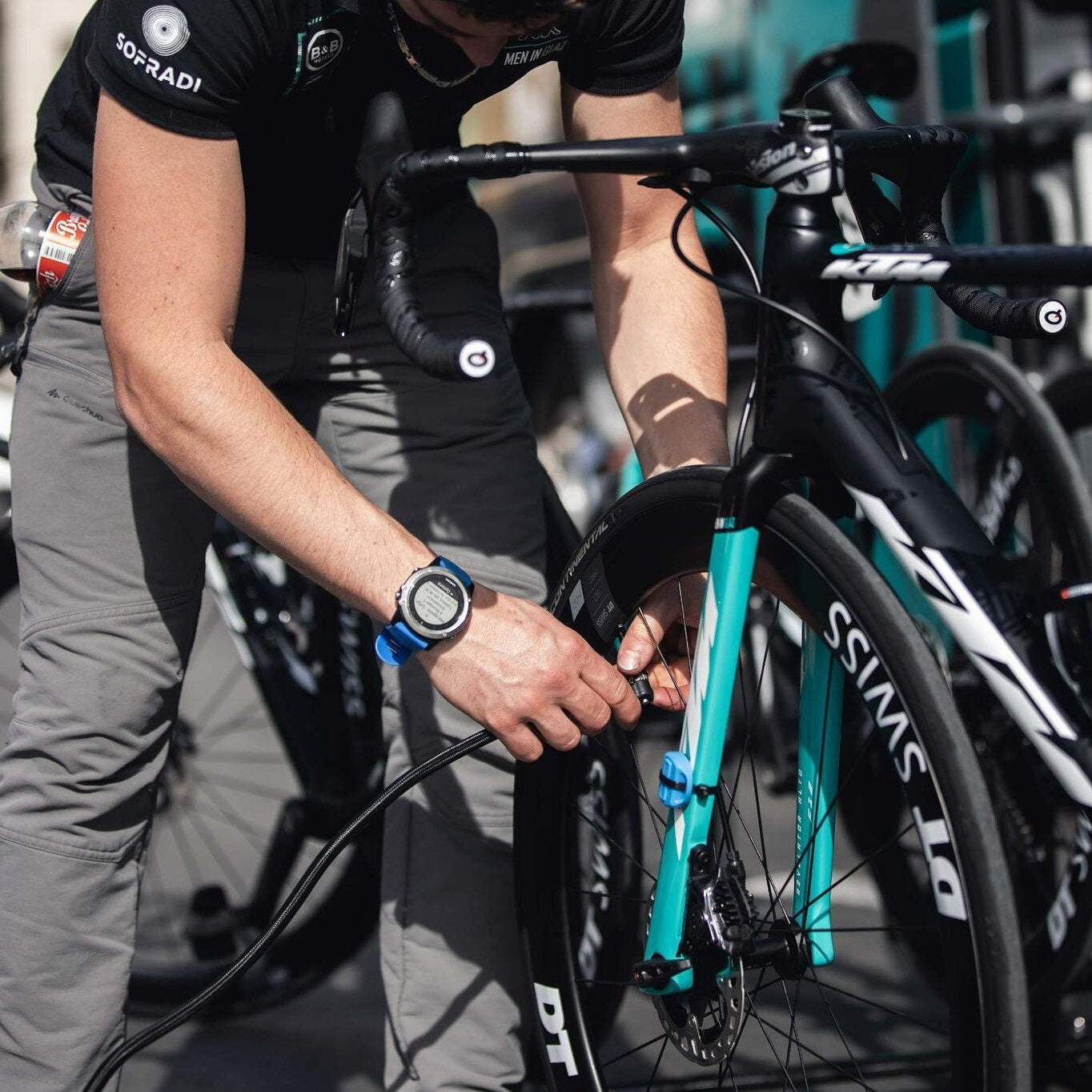 A picture of someone pumping up road bike tyres