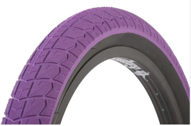 Purple BMX Tyre with tread pattern on a white background