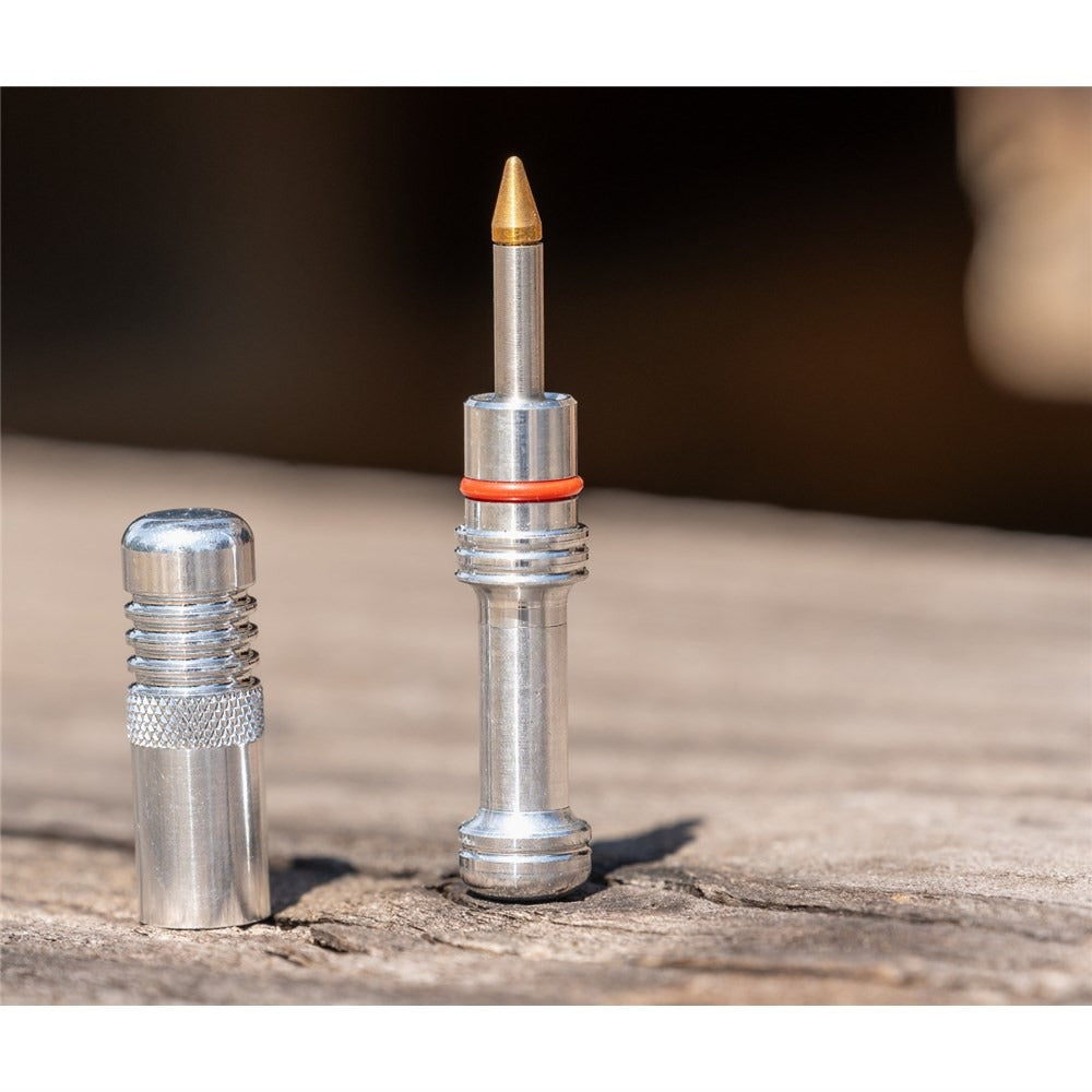 A silver bicycle tubeless repair kit posed on a block of wood