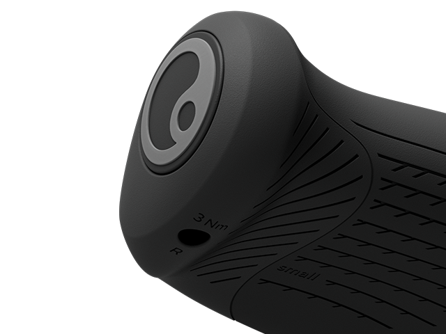 Close up of a bar end on a black mountain bike grip on a white background