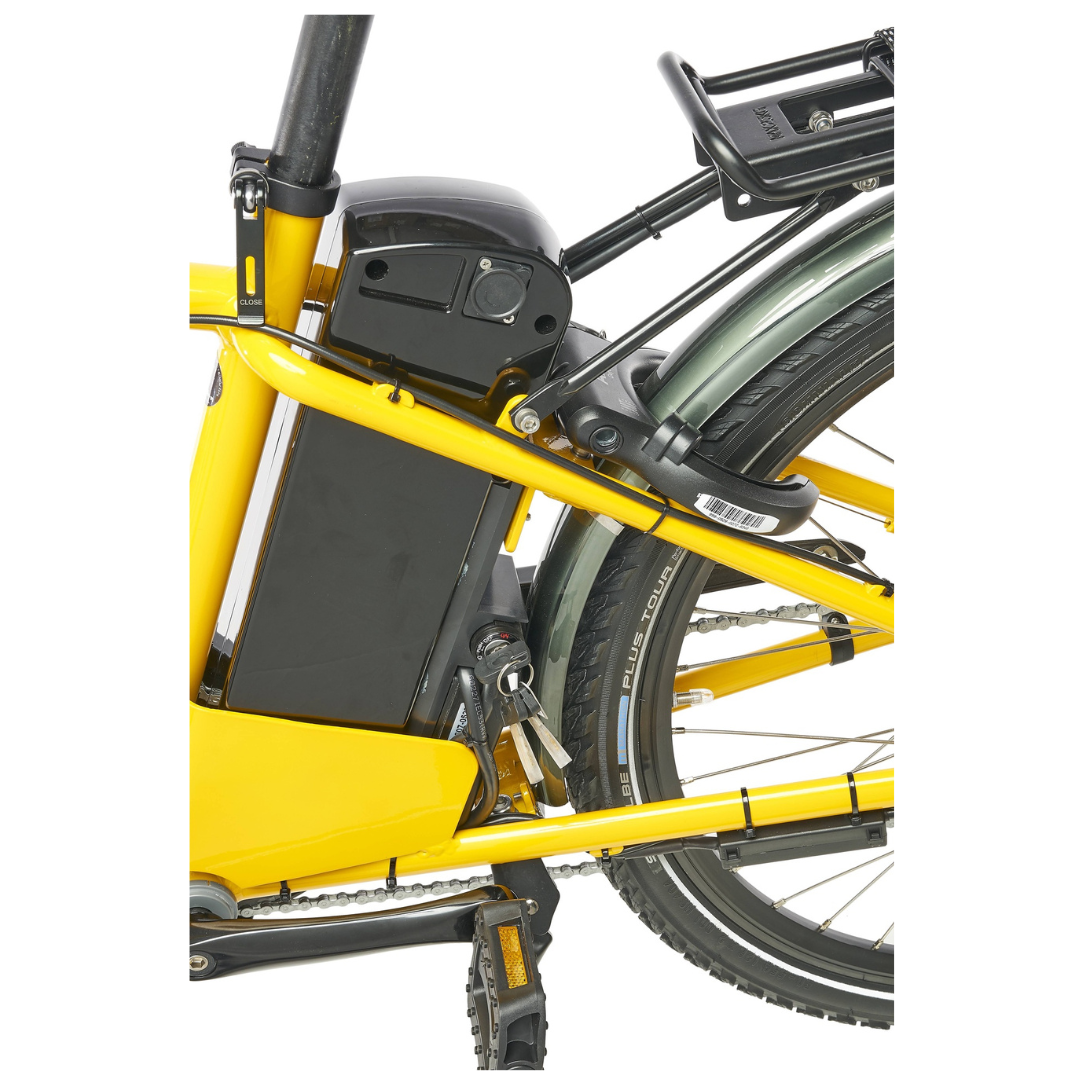 Close up of a Yellow electric bicycle with a black battery pack attached to the frame on a white background