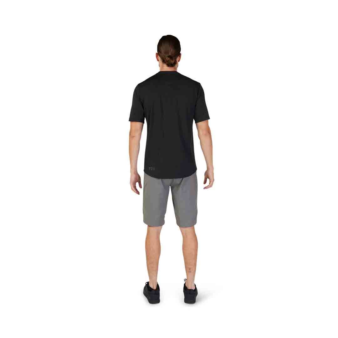 A picture from the back of a guy wearing a black Fox Ranger SS Labhead MTB Jersey