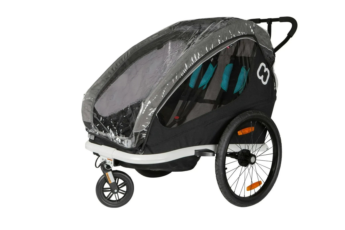 A black kids bike trailer on a white background