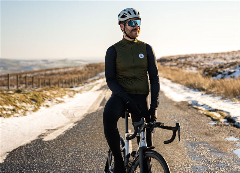 A picture of a man wearing a Lazer Tonic Kineticore Helmet while sitting on a road bike