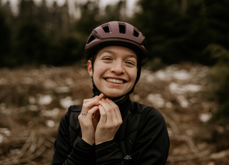 A lady wearing a Lazer Tonic Kineticore Cosmic Berry Helmet