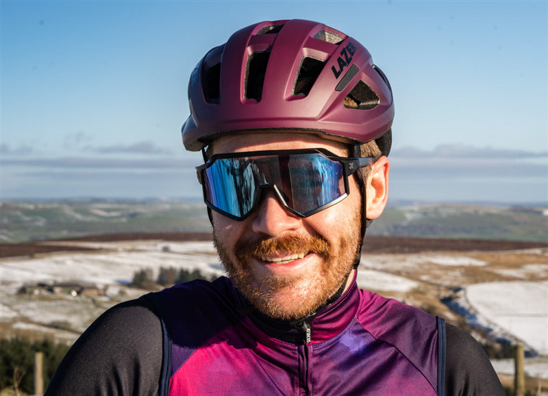 A man wearing a Lazer Tonic Kineticore Cosmic Berry Helmet