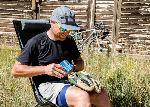 Man fitting Shimano SPD Cleats to shoes sitting outside
