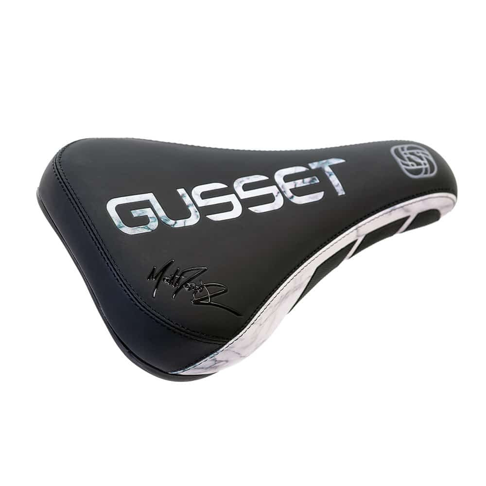Black bicycle saddle with 'Gusset' branding on a white background