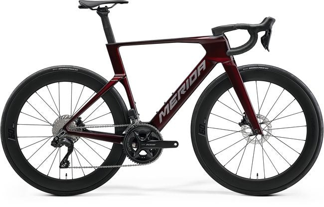Red Merida road bike on a white background