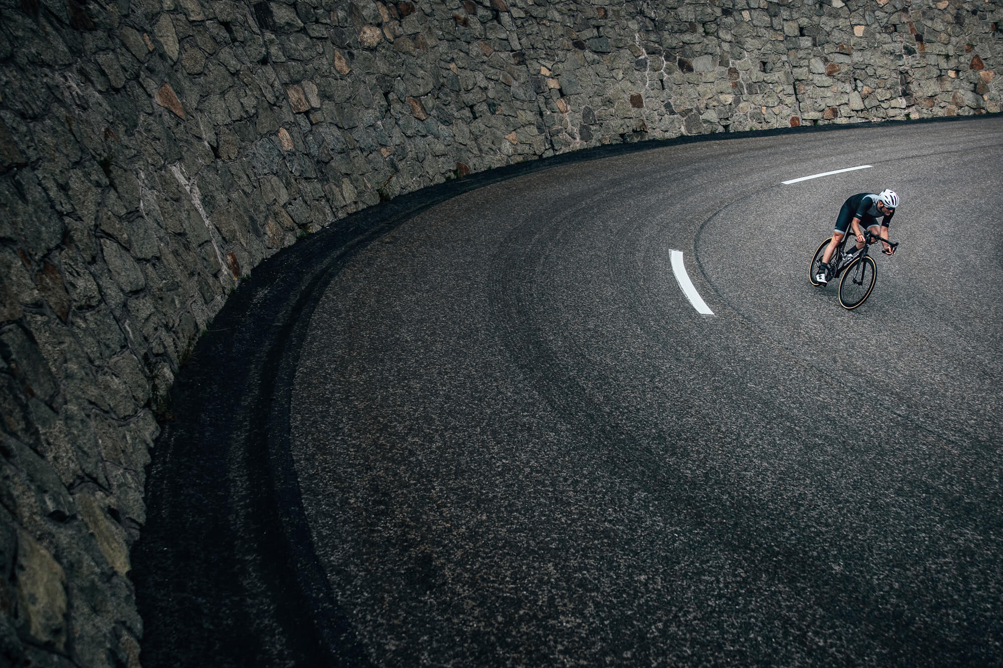 A picture of a man riding a road bike wearing the Met Rivale II MIPS Road Helmet