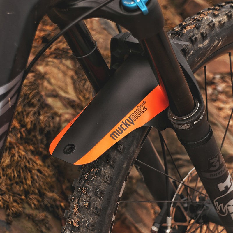 A picture of the orange Mucky Nutz Face Fender Mudguard Orange fitted to a mountain bike