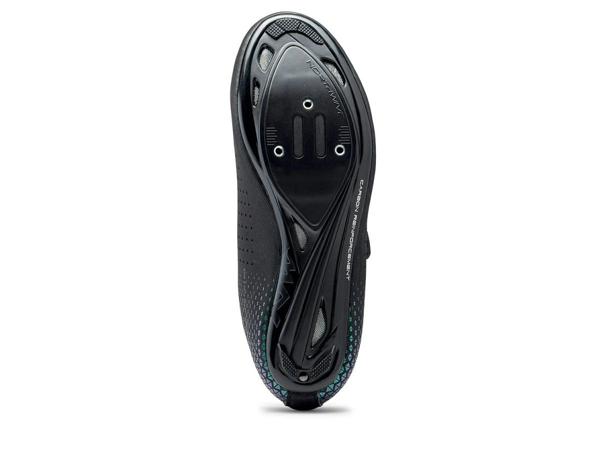 The sole of a black cycling shoe sole on a white background