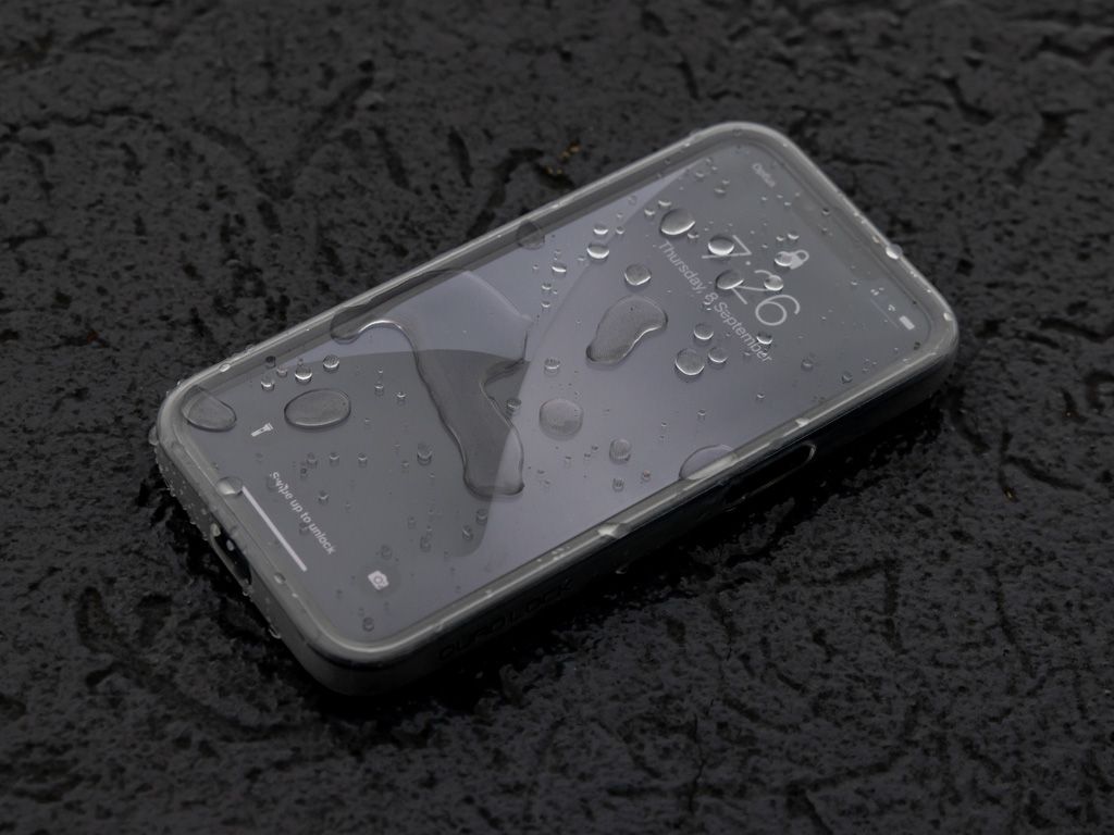 A picture of a phone in a Quad Lock case covered in water