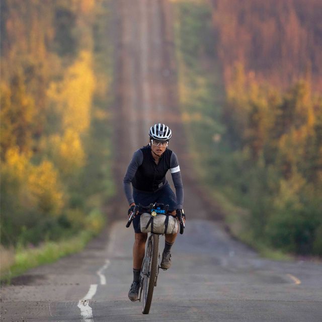 A picture of someone riding a gravel bike with a quad lock phone mount system on the handlebars