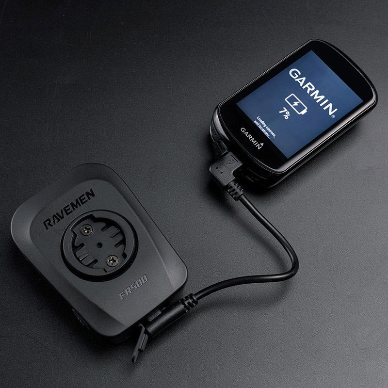 Ravemen power adapter with a Garmin device on a dark surface