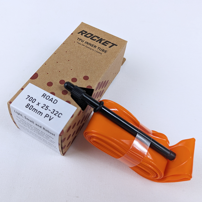 Orange Rocket TPU Inner Bicycle Tube with black valve on a white background