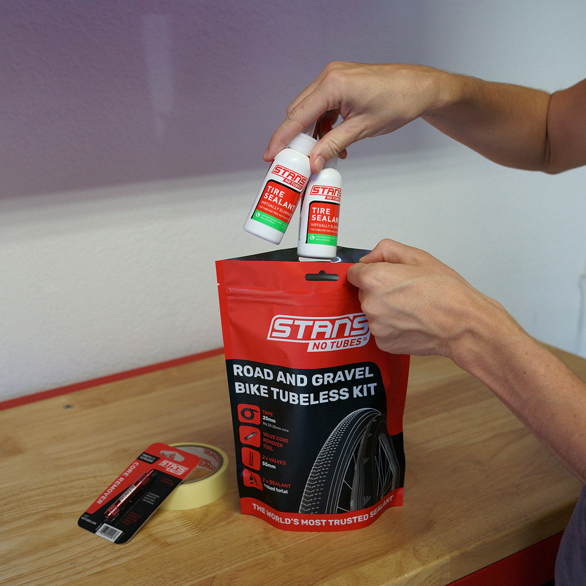 A picture of someone taking out the products from the Tubeless Kit for Road or Gravel