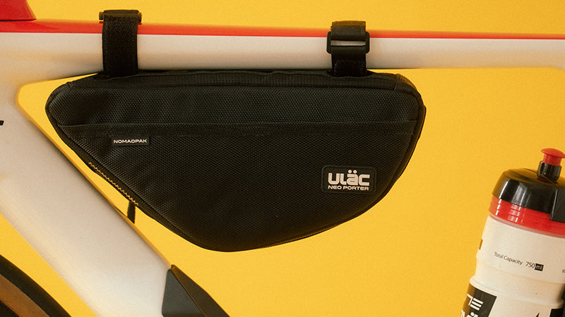 A picture of the black Ulac Touring Pro 1.5L Frame Bag attached to the underneath of the top tube on a bike