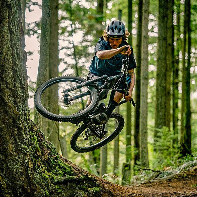 A picture of a bloke jumping a mountain bike with a Bell 4 Forty Helmet on his head