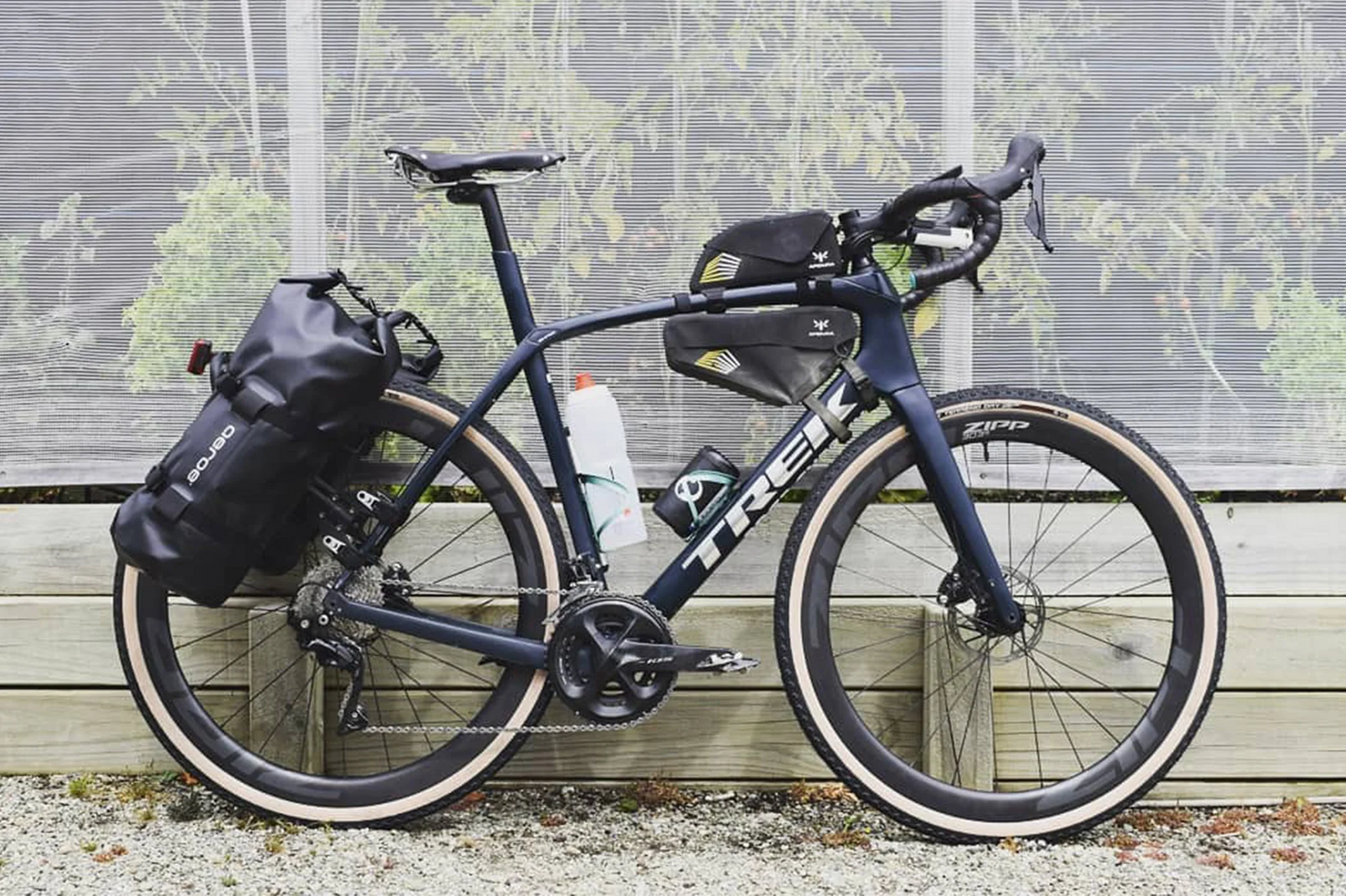 A picture of a gravel bike the Aeroe Spider Rear bike rack and cradles with bags attached