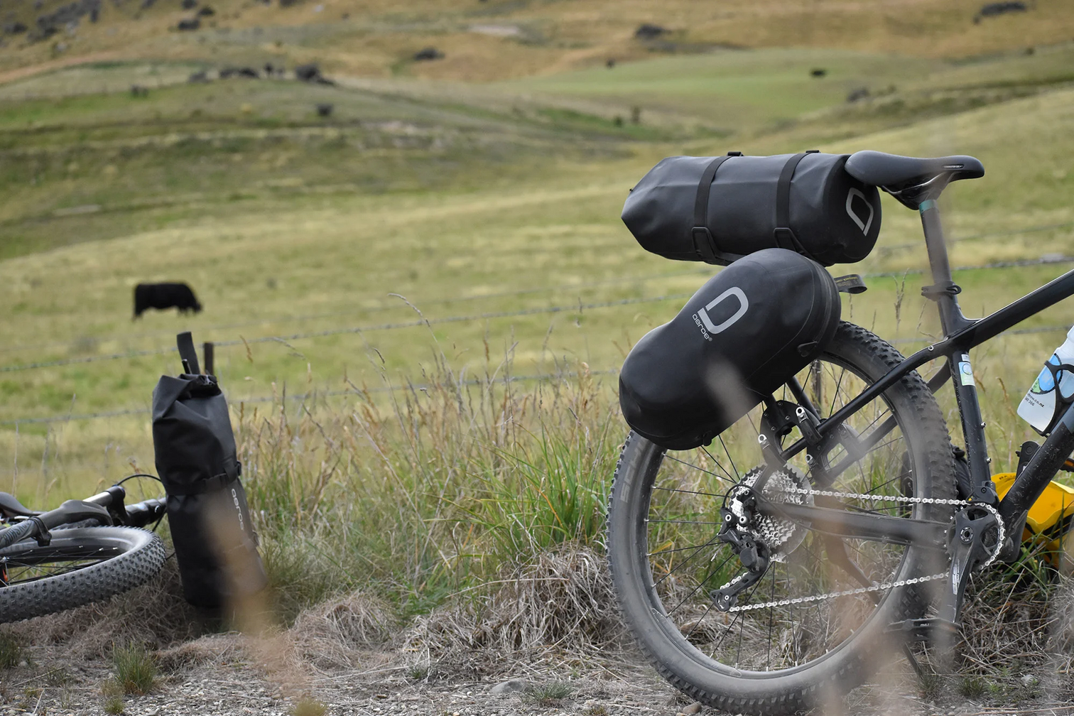 a picture of the Aeroe 12 Litre Dry Bicycle Bag attached to a mountain bike