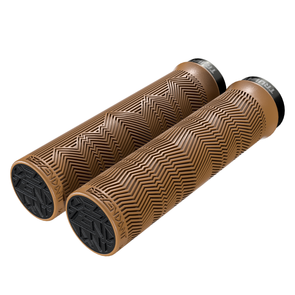 A pair of light brown bicycle handgrips on a white background