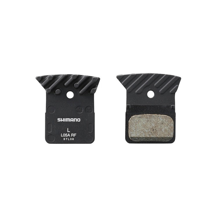 Two Shimano brake pads on a white background