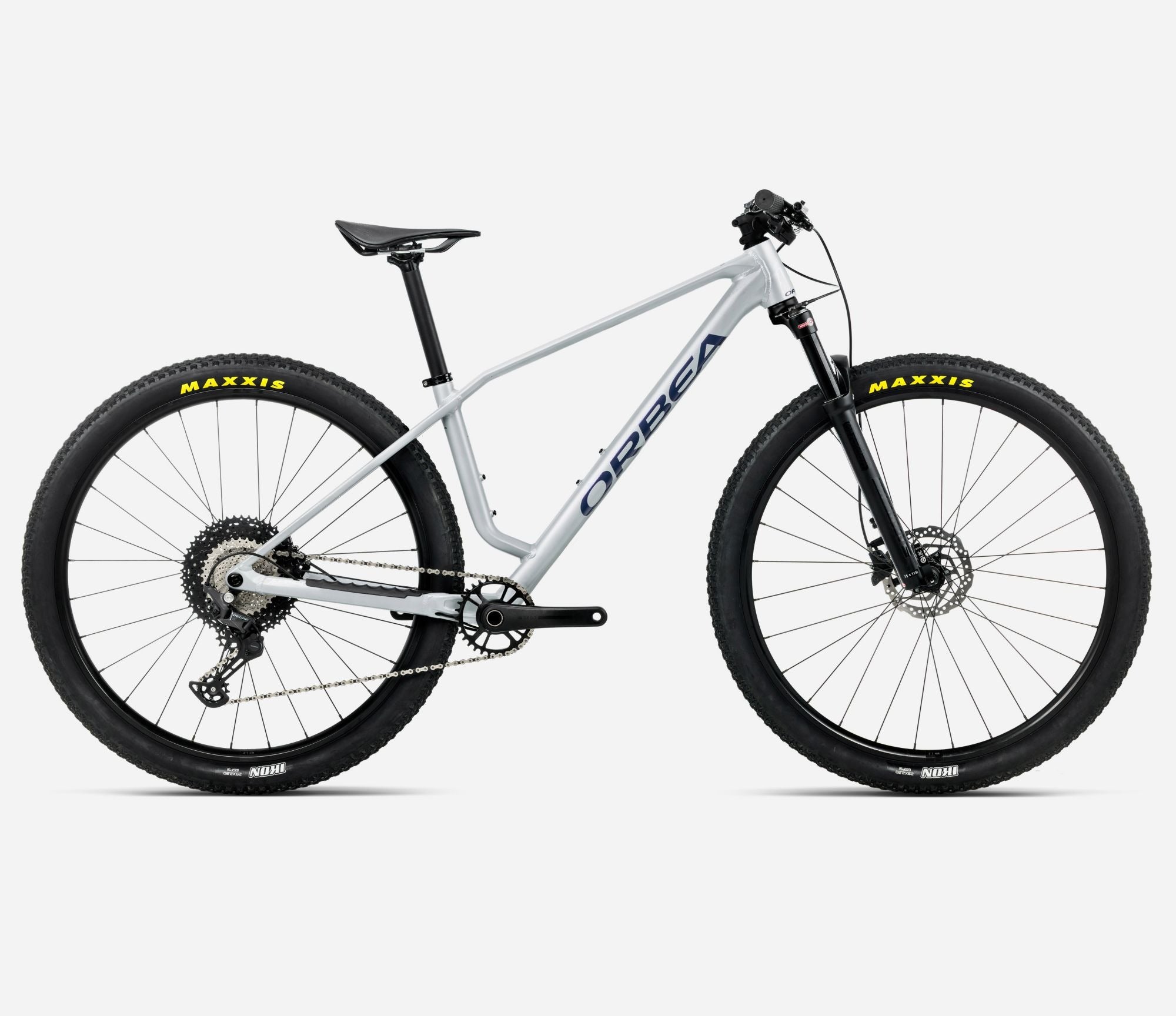 Silver Orbea mountain bike with black tyres on a white background