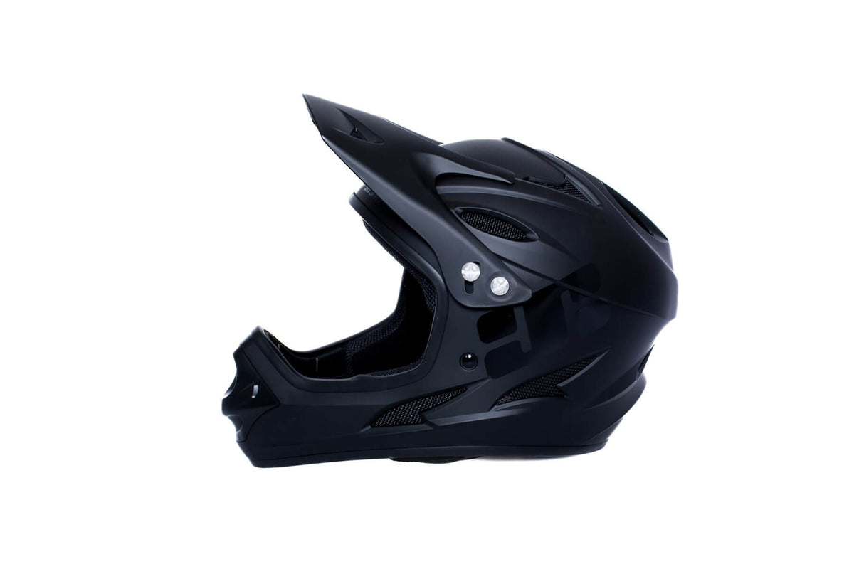 A side view of a black full face mountain bike helmet on a white background