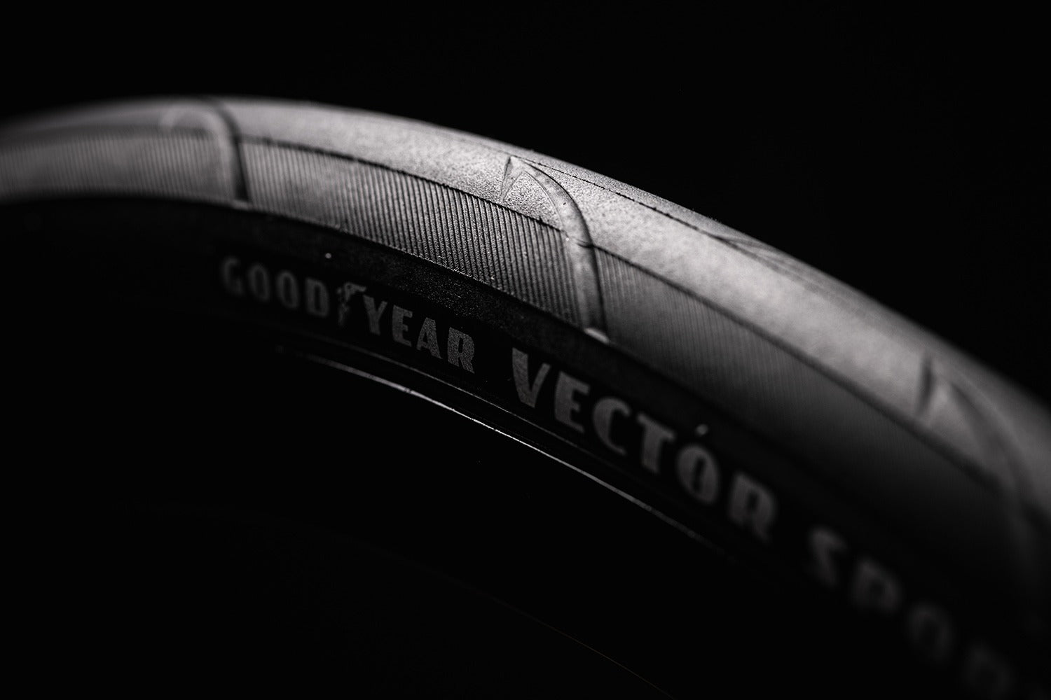 Close-up of a Goodyear Vector Sport tire tread pattern on a black background