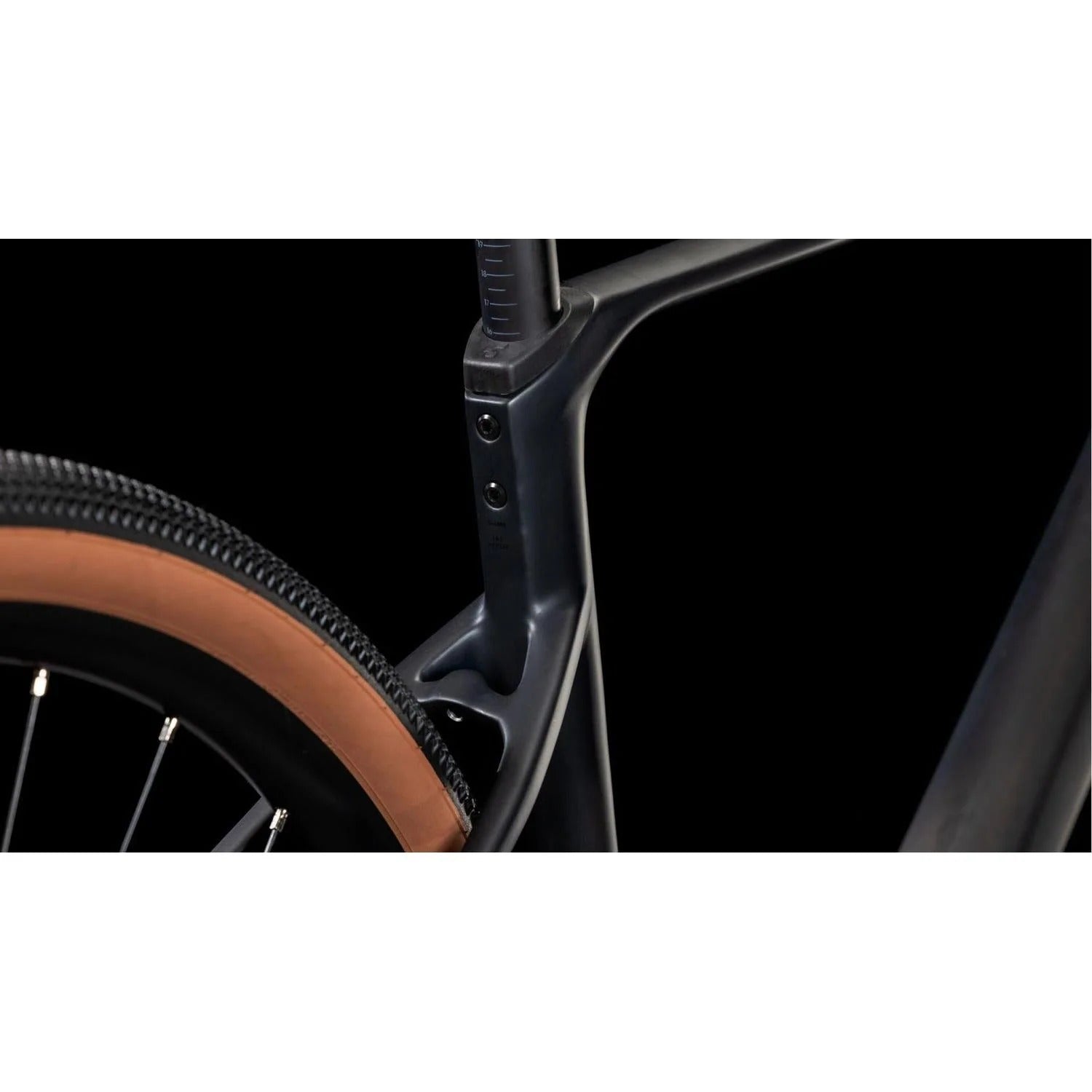 Close-up of a gravel bike wheel and frame on a black background